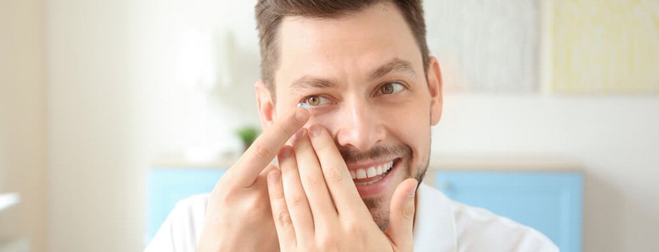 Man putting in contact lens