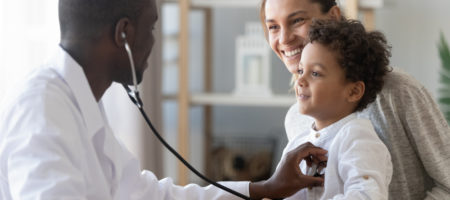 A mother and child receiving a check-up with their doctor.