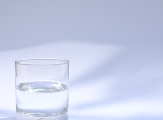 An image of a drinking glass filled with clear liquid